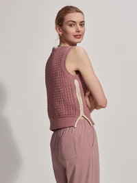 Model wearing a dusky pink round neck vest top, side view.