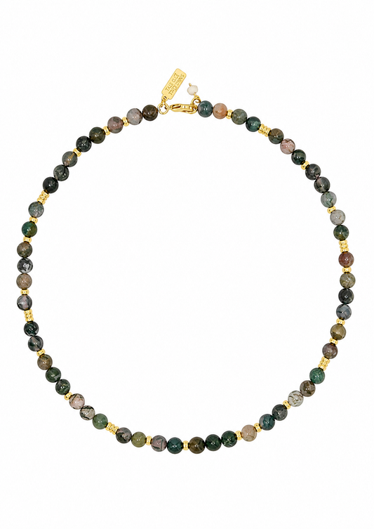 A beaded necklace made of small round natural stone beads in earthy green, brown, gray, and black tones, separated by small gold spacer beads and a gold clasp, shown on a plain white background.
