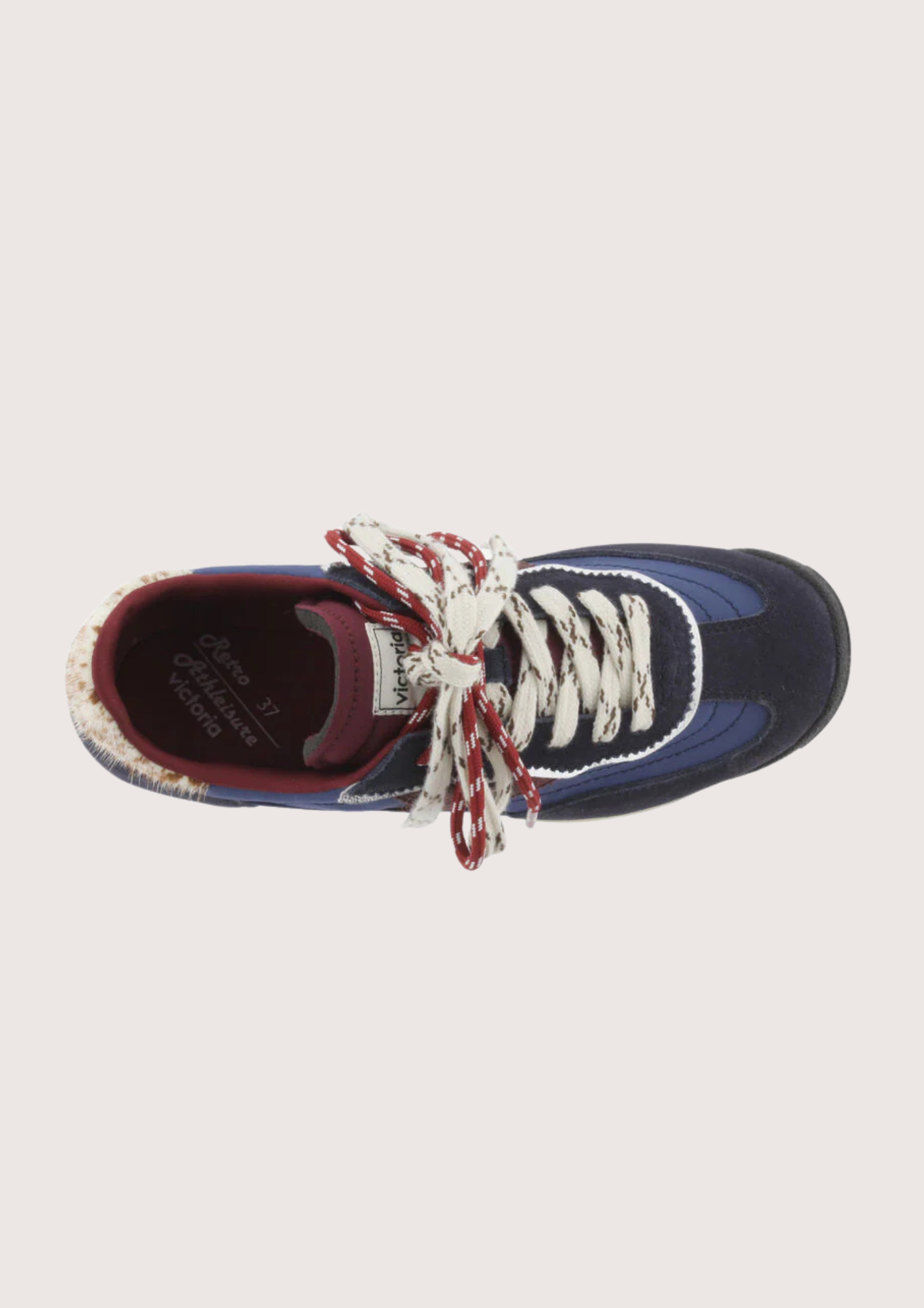 A low-top fashion sneaker, featuring navy blue suede and mesh panels, burgundy accents, patterned white and burgundy laces, and a cream midsole, shown against a plain light gray background.