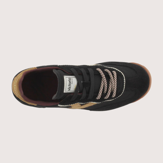 A black suede and mesh low-top sneaker with tan side panels, burgundy lining, and a cream midsole, shown from a side profile on a light gray background.