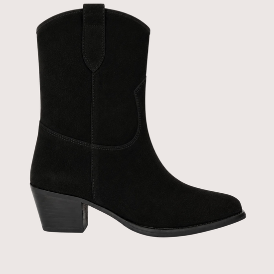 A black suede western-style ankle boot with a low block heel, shown from a side profile against a light beige background.