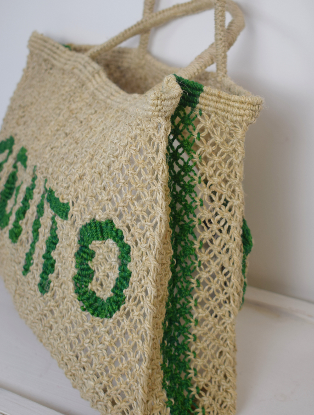 Neutral woven bags with green writing saying 'Mojito"