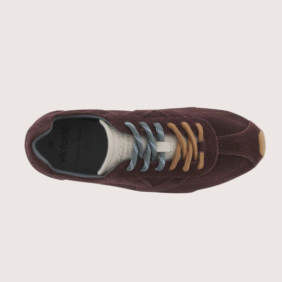 Brown suede sneaker with beige sole on a white background