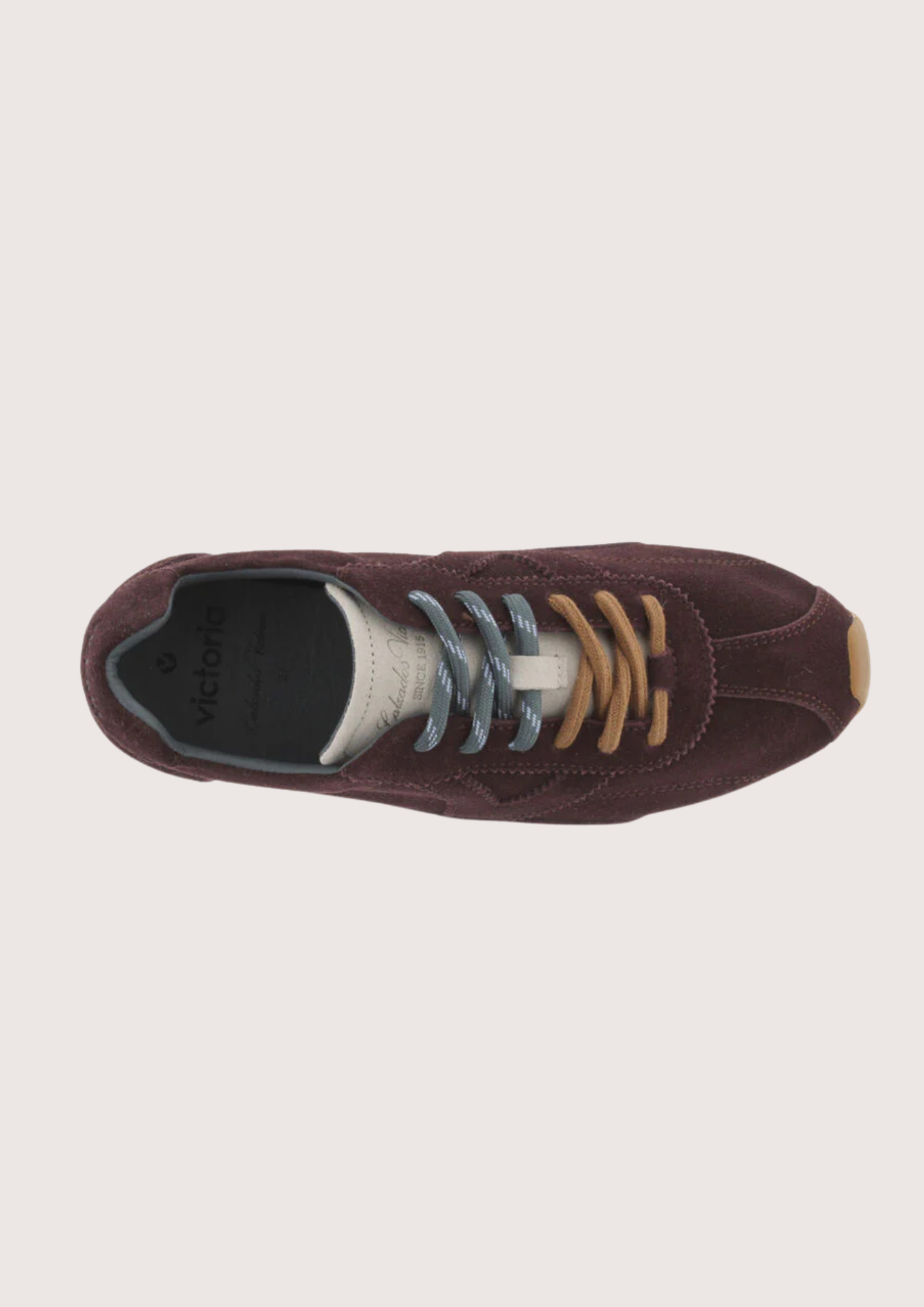 Brown suede sneaker with beige sole on a white background