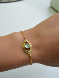 Gold evil eye bracelet with green opal stone 