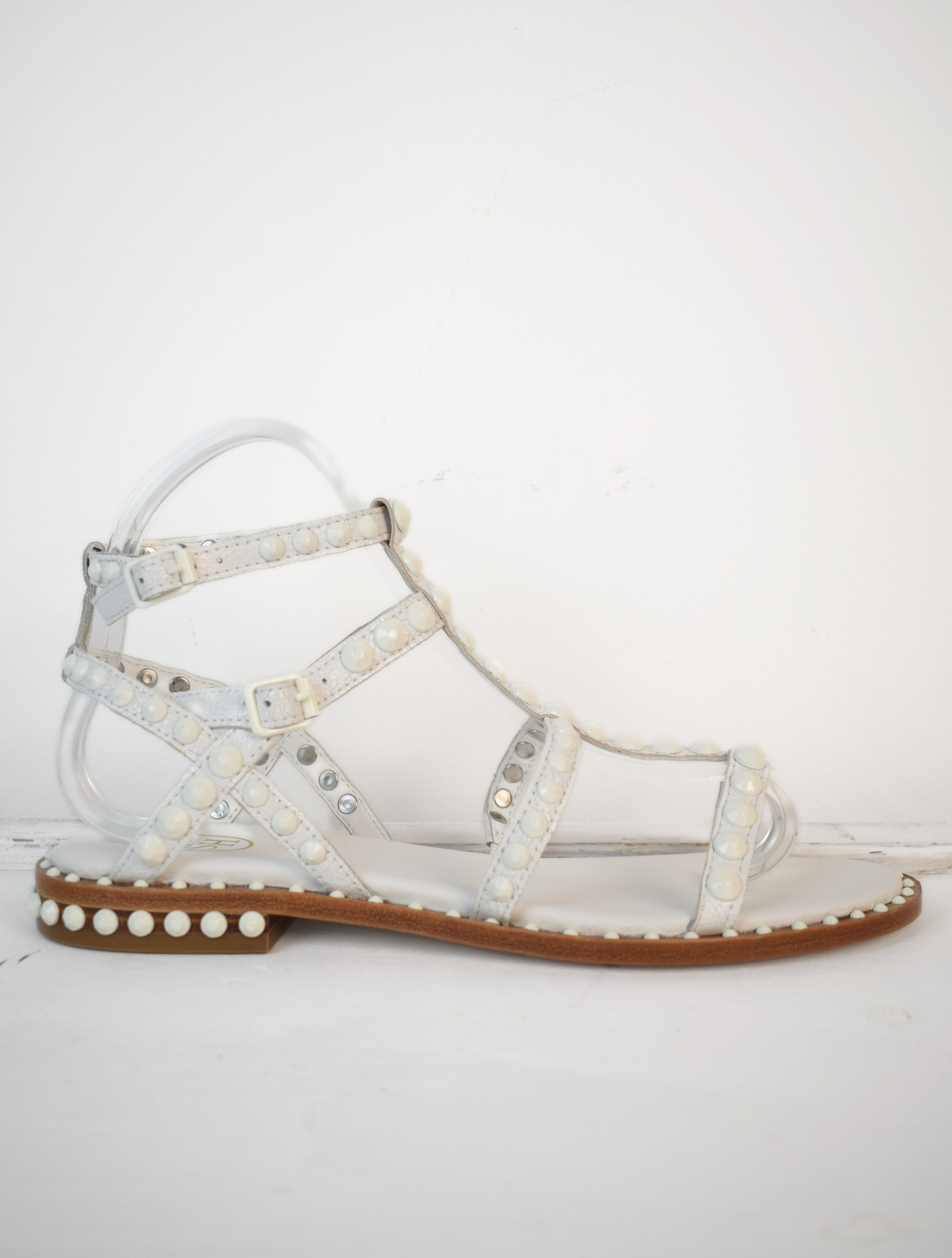 White studded gladiator sandals with tan sole  