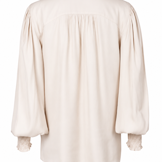 A cream-colored long-sleeve blouse with gathered, balloon sleeves and delicate lace trim at the collar and cuffs, shown from the back on a white background.