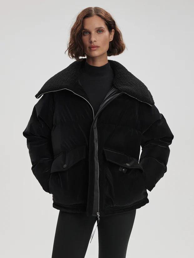 black oversized puffer with sherpa collar and 2 front flap pockets  model shot