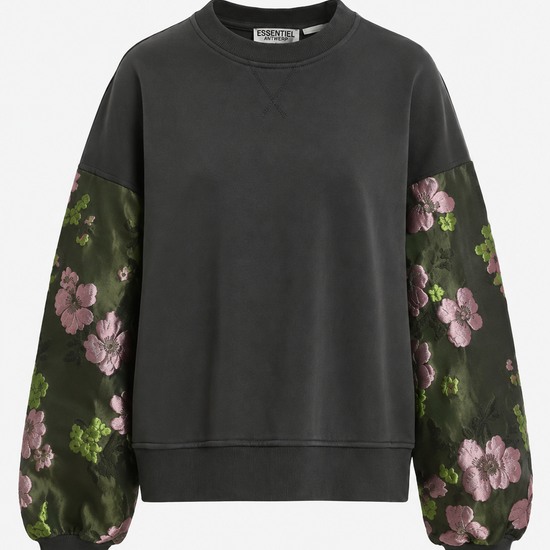 A dark charcoal gray crewneck sweatshirt with long sleeves featuring a green floral print with pink flowers, shown against a plain white background.