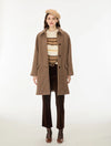Woman wearing a brown check wool coat and a beret