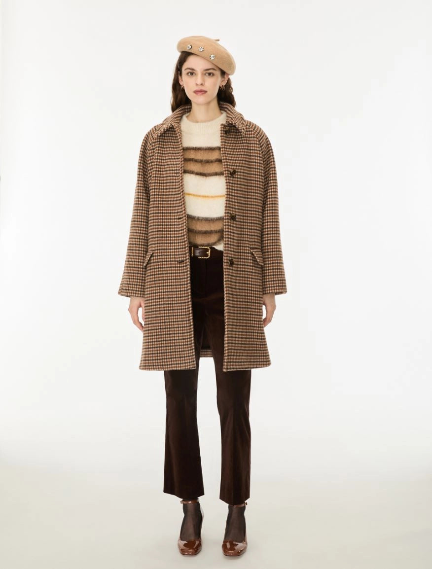 Woman wearing a brown check wool coat and a beret