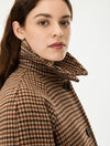 Woman wearing a brown check wool coat close up