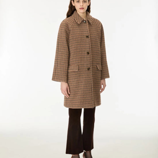 Woman wearing a brown check wool coat done up