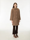 Woman wearing a brown check wool coat done up