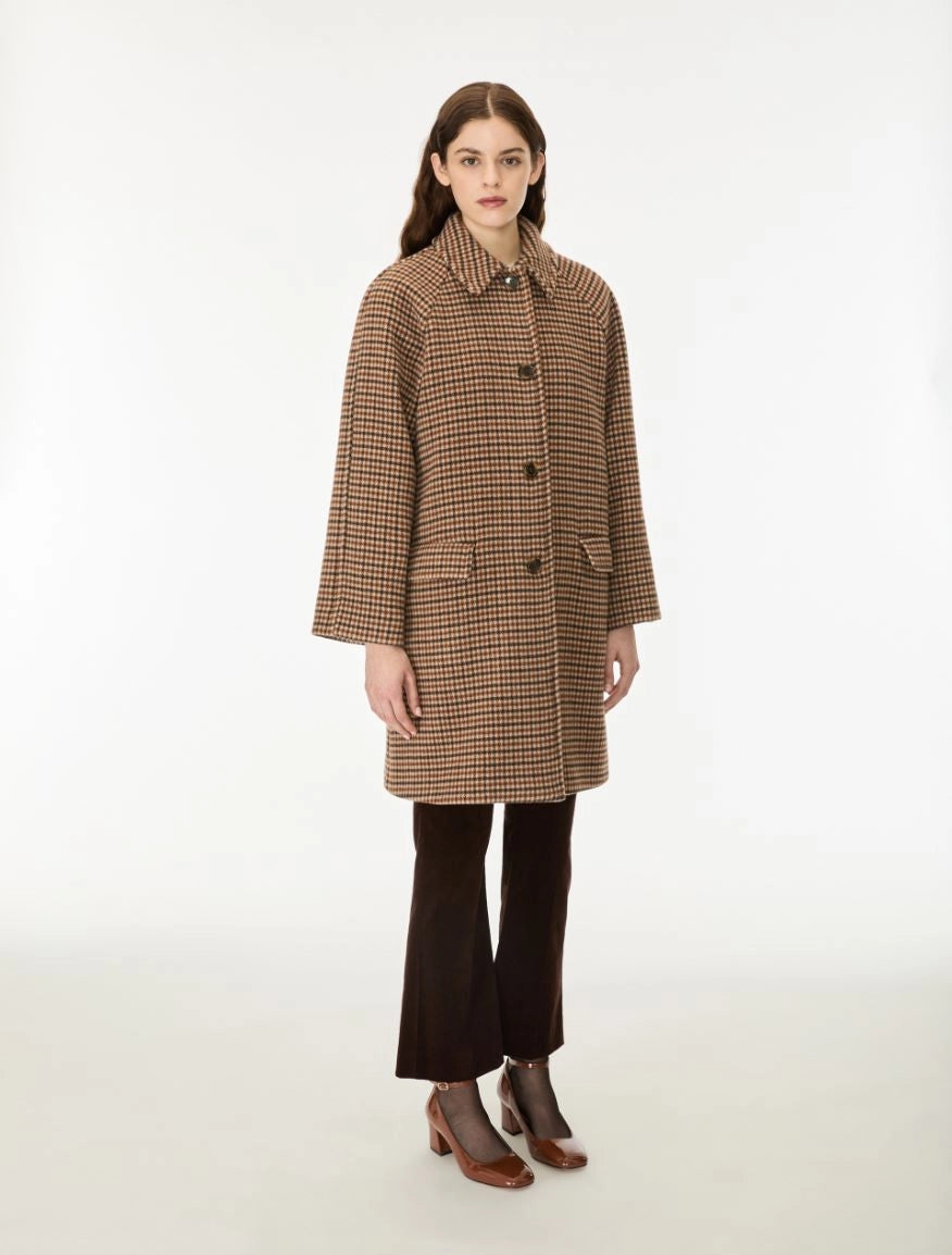 Woman wearing a brown check wool coat done up
