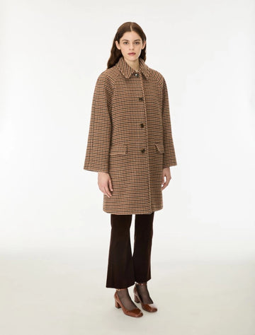 Woman wearing a brown check wool coat done up