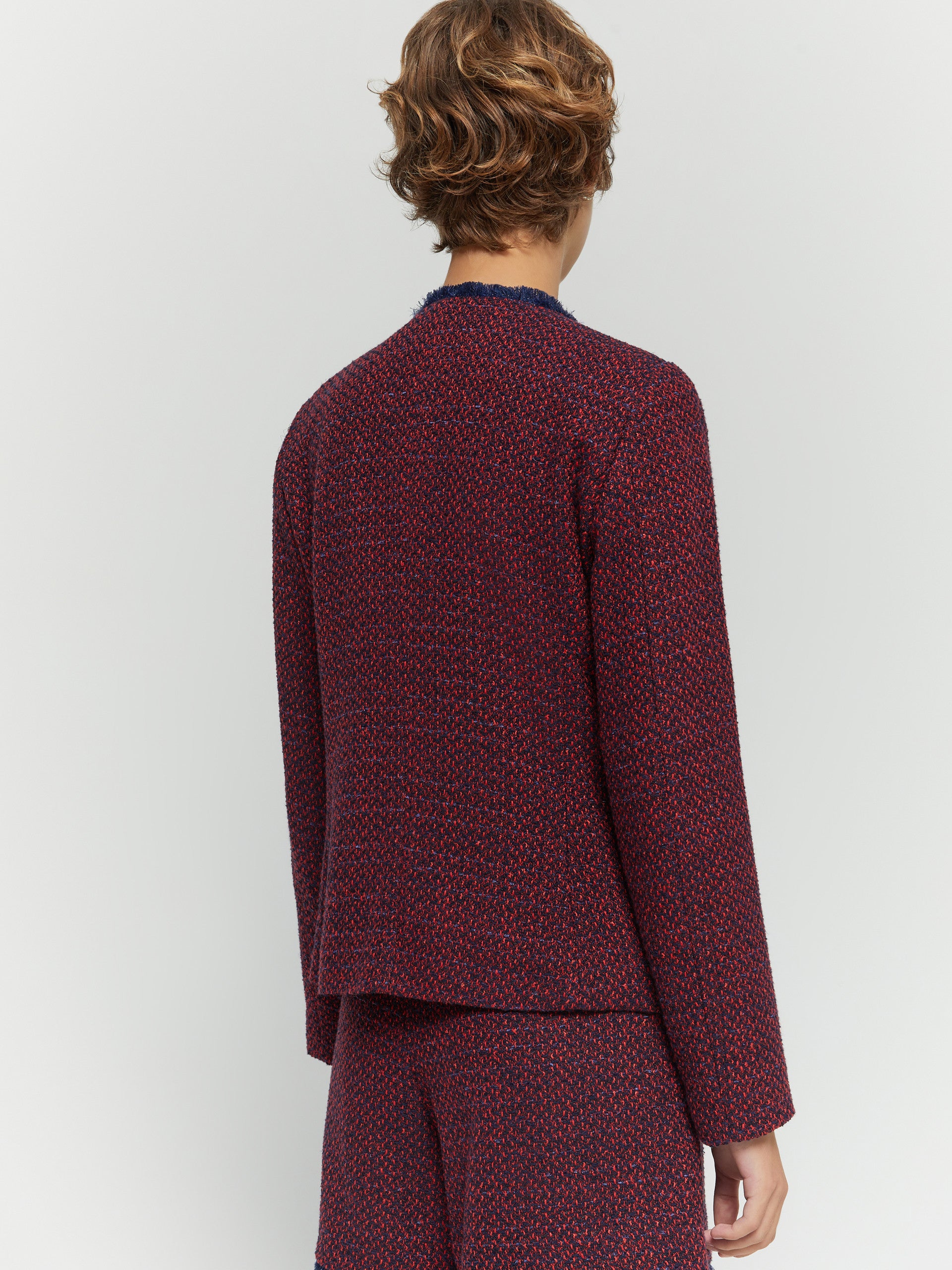 Rear view of red and navy woven jacket