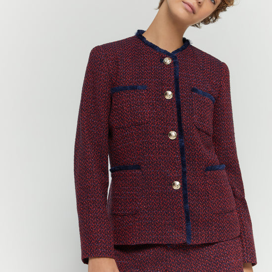 Model shot of woven jacket with gold toned buttons paired with matching short