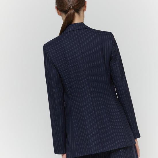 Rear view of navy pinstripe blazer on model