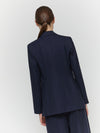 Rear view of navy pinstripe blazer on model