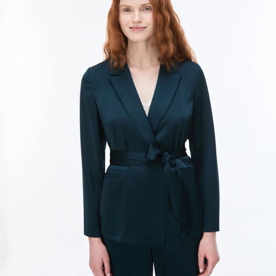 woman wearing teal blazer and trousers 