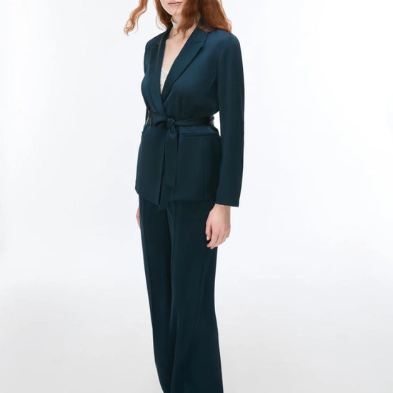 woman wearing dark deal suit and silver heels