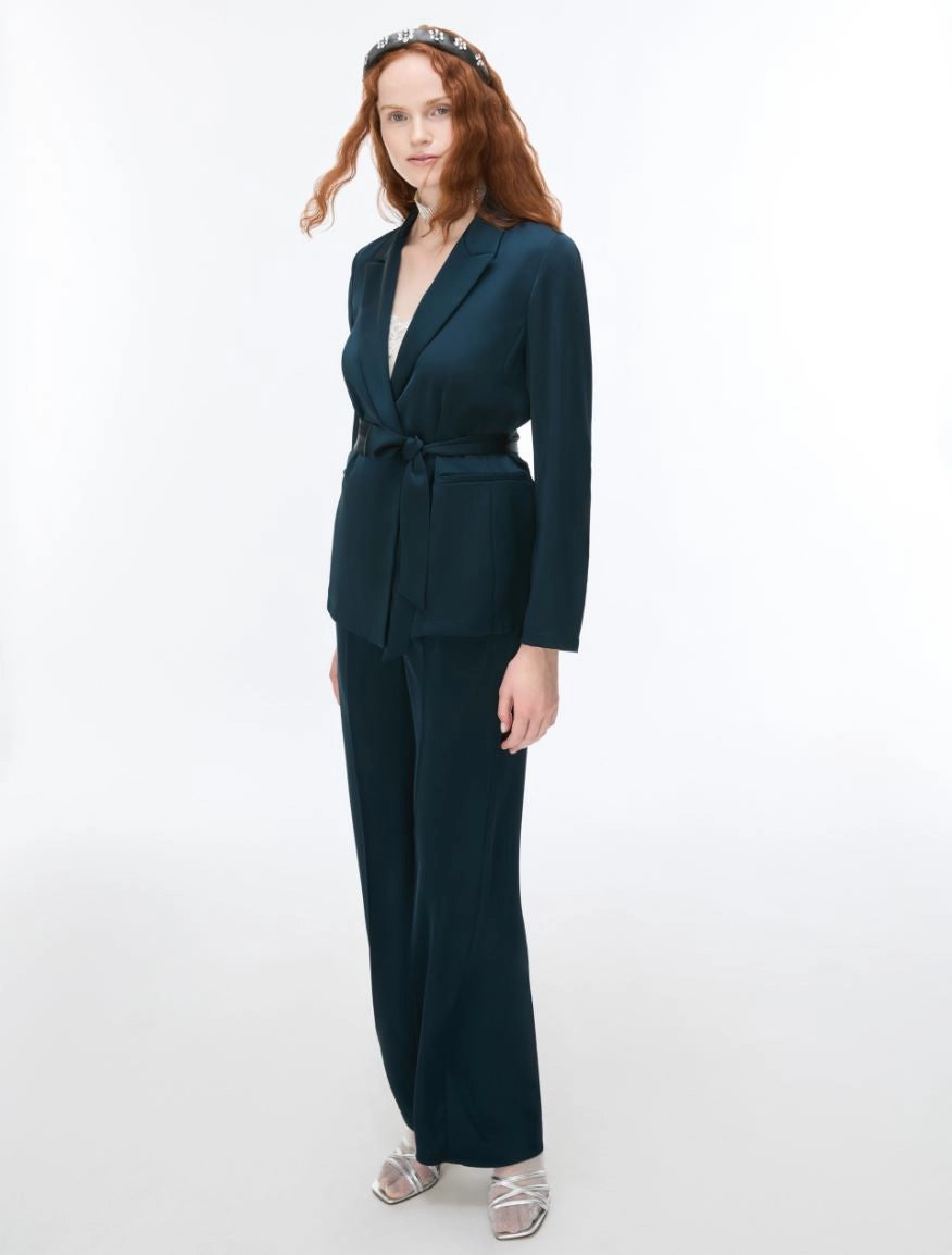 woman wearing dark deal suit and silver heels
