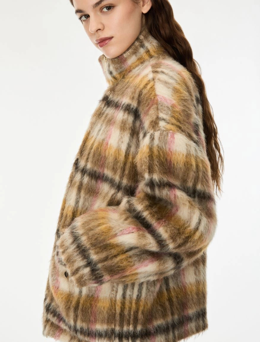 woman wearing khaki and pink check coat on a white background side view