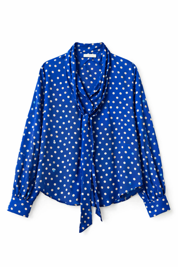Blue polka dot blouse with a tie detail on a white background