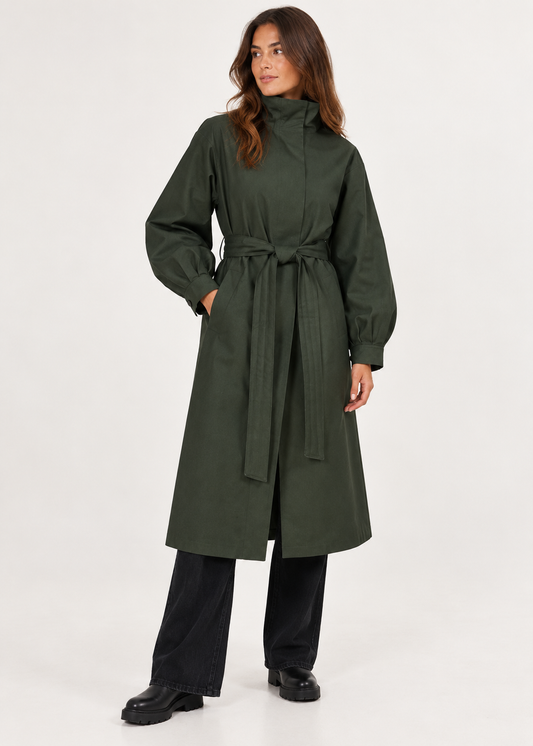 model wearing a green long waterproof coat on a plain white background