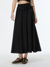 Person wearing a black skirt with a white background