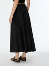 Black skirt worn by a person on a white background
