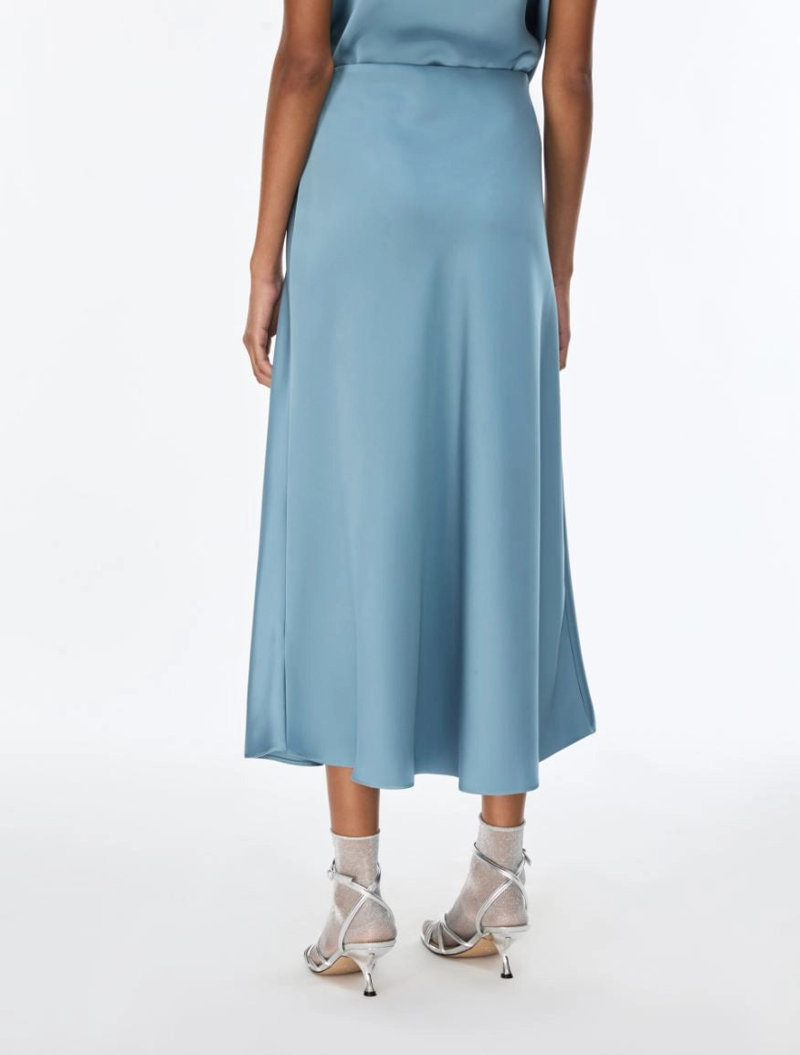 woman wearing light blue satin skirt rear view