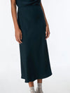Dark green skirt and top worn by a person on a white background