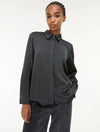 woman wearing grey satin shirt on a white background side view
