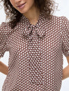 geometric blouse with neck tie on white background close up