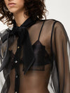 black sheer blouse with tie neck, long puffy sleeves and chest pockets close up