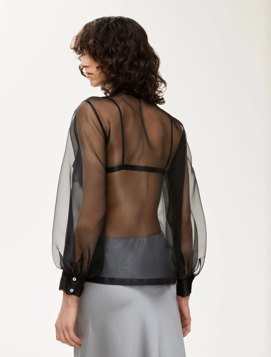 black sheer blouse with tie neck, long puffy sleeves and chest pockets rear view 