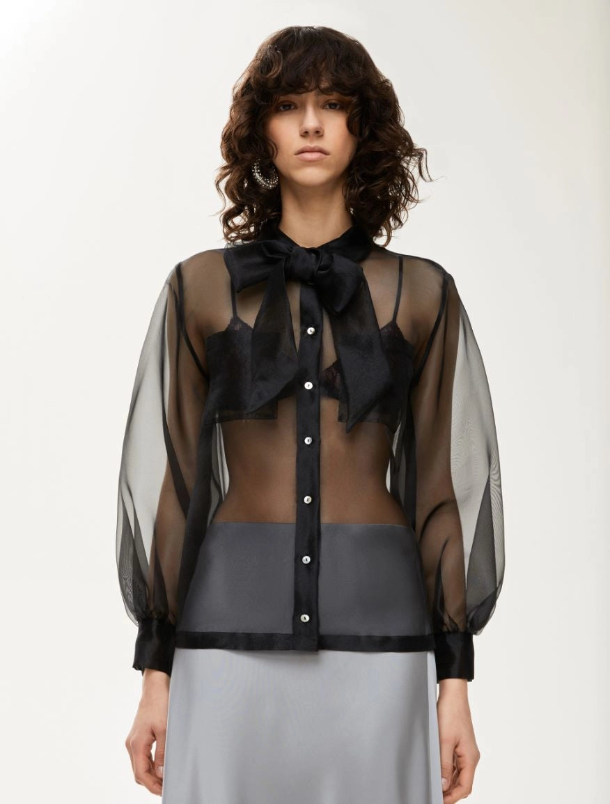 black sheer blouse with tie neck, long puffy sleeves and chest pockets model shot