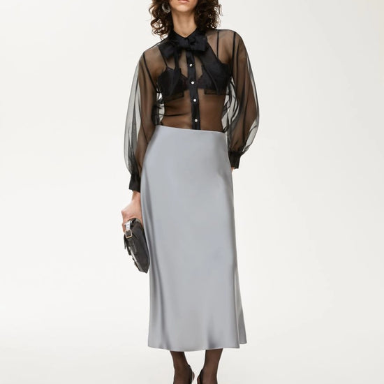 black sheer blouse with tie neck, long puffy sleeves and chest pockets model shot