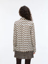 Person wearing a polka dot shirt with a white background
