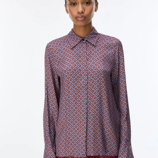 woman wearing a blue and red pattern shirt and red skirt on a white background