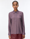 woman wearing a blue and red pattern shirt and red skirt on a white background