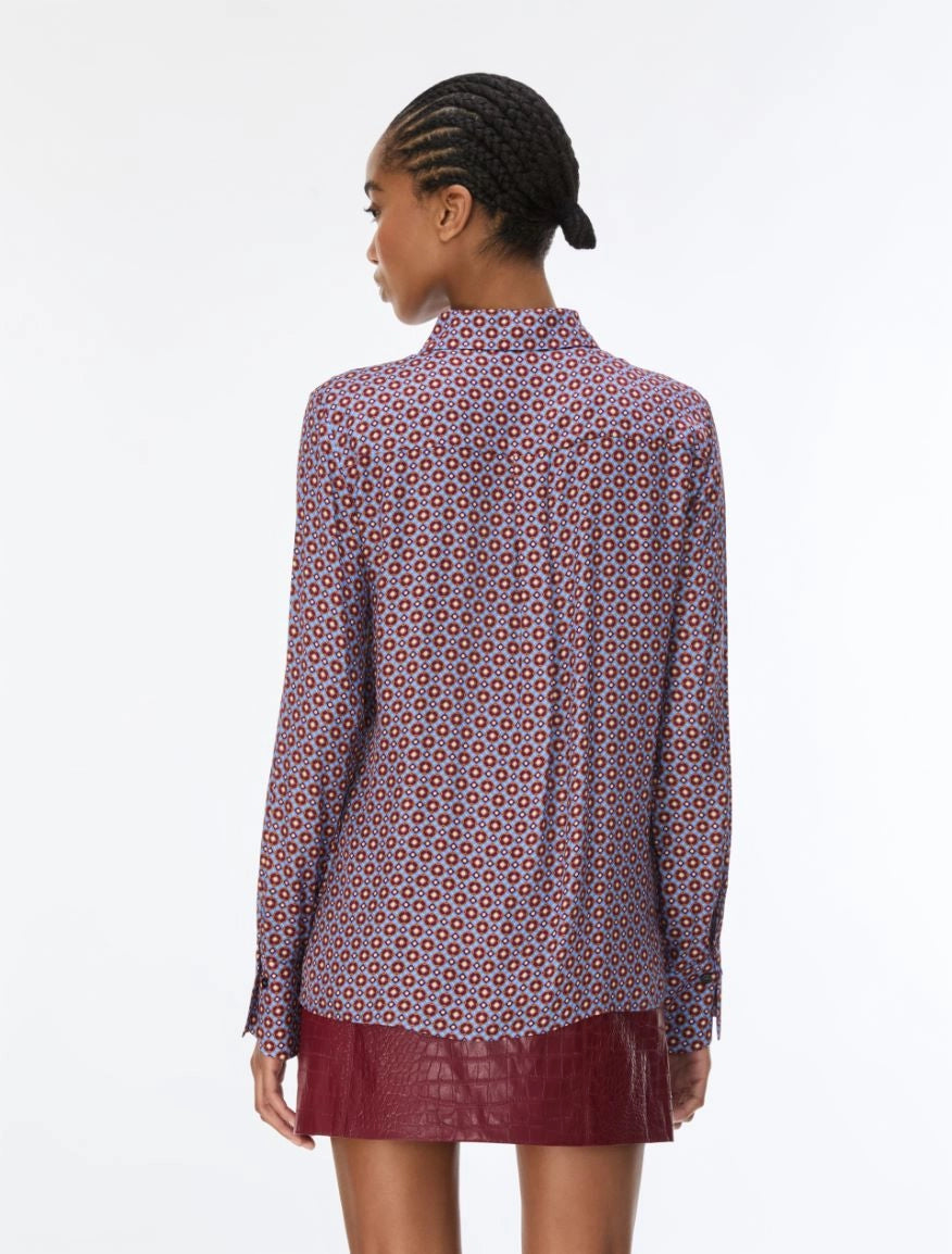 woman wearing a blue and red pattern shirt and red skirt on a white background rear view