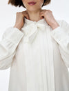 white blouse with neck tie on white background close up 