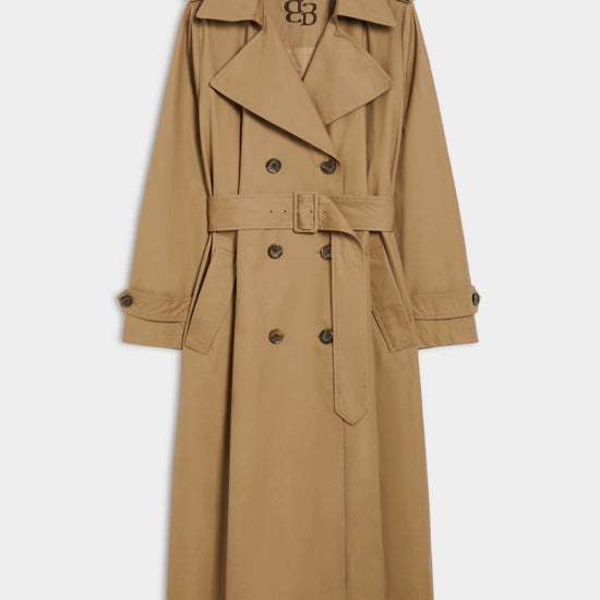 Tan trench coat with a brand logo in back of neck on a white background