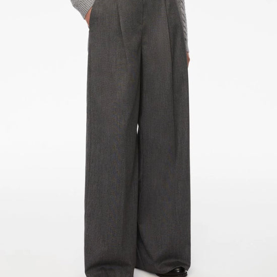 Person wearing gray wide-leg pants on a white background from iBlues