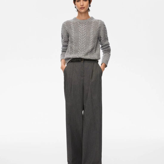 Person wearing a gray sweater and dark gray wide-leg pants on a white background from iBlues