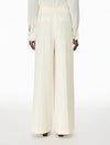 Woman wearing cream trousers rear view