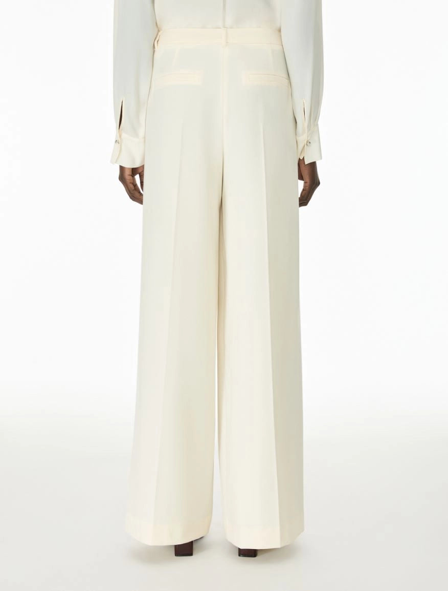 Woman wearing cream trousers rear view